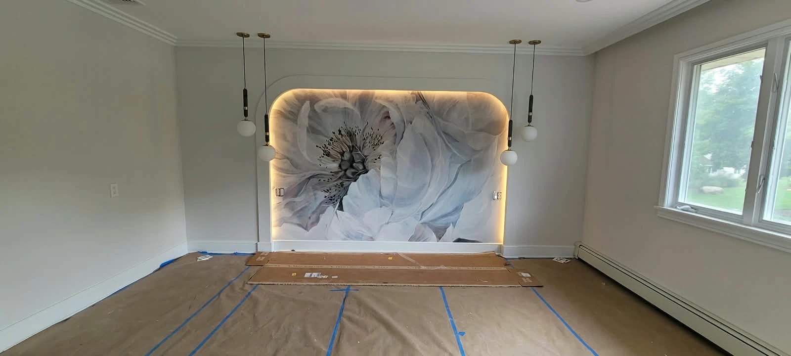 Finished bedroom with backlit mural feature wall, pendant lights, crown moulding and trim