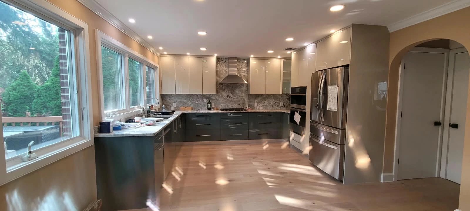 Finished kitchen with stone counters, full-height backsplash and new appliances